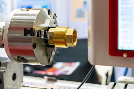 Copper pipe fitting or brass joint inside and outside thread setting on spindle chuck of automatic...