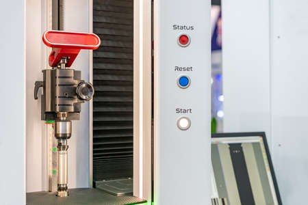 Cylindrical metal workpiece during setup on high technology and precision optical measuring machine...
