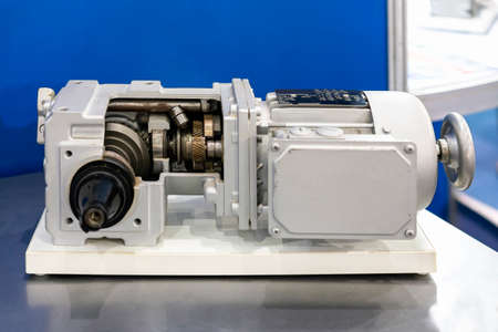 cross section show metal various cogs gear bearing housing shaft and detail inside of transmissions gearbox for industrial assembly with electric induction motorの写真素材