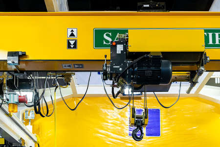 Close up electric over head crane hoist with trolley frame drive unit wire rope hook block for lifting and transfer object and reduce work loadの写真素材