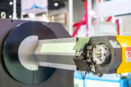 Close up rotation head or turning arm of automatic and precision continuous cnc 3d steel wire bending machine fast speed for stable forming production in industrialの写真素材