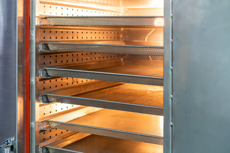 Empty stainless basket mesh in pastry oven for manufacture in food industrialの写真素材