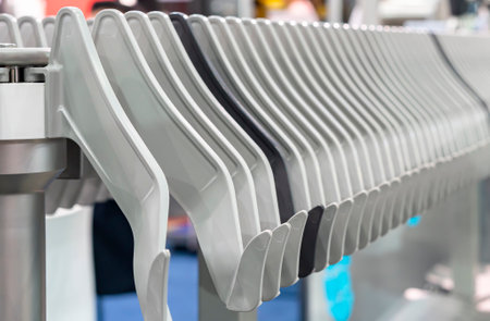 Close up automatic hanging conveyor belt line machine holder for sausages transport in manufacturing process food industrialの写真素材