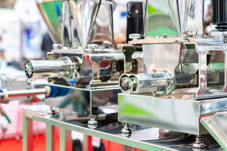Close up stainless steel worm mincer screw at outlet tube or discharge gate of commercial grinder or masher machine for food industrialの写真素材
