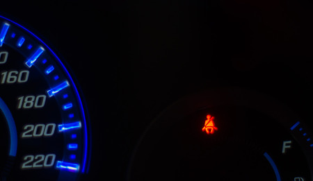 Speedometer and Seat belt warning light signals,at night.の写真素材