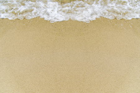 Smooth sand and beautiful waves, suitable as a background for writing messages.の写真素材