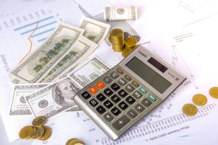Investors are calculating profits and interest rates using a calculator and have a small amount of money.の写真素材