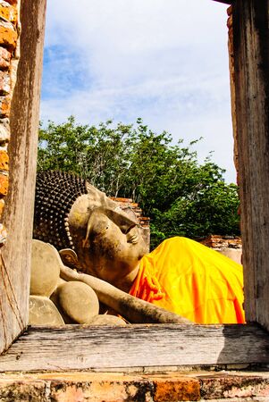 image of Buddha lie in the wood frame windowの写真素材