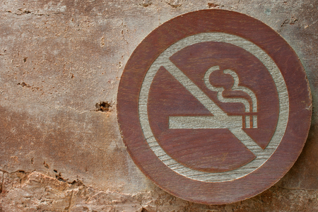 No Smoking Signs on brown wall.の写真素材
