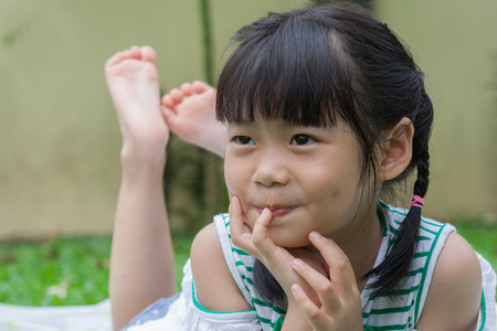 Shoot girl and children portrait in garden.の写真素材