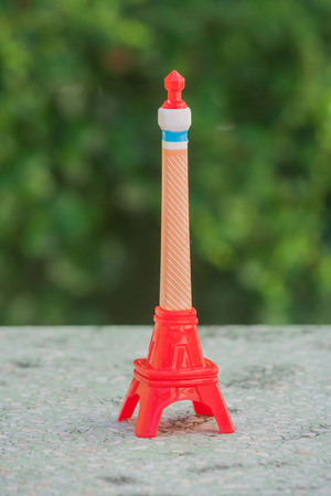Little colorful model of Eiffel tower with green color background.の写真素材