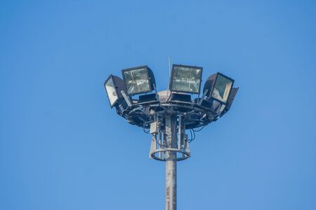 Spotlight surrounded with blue sky background in public park.