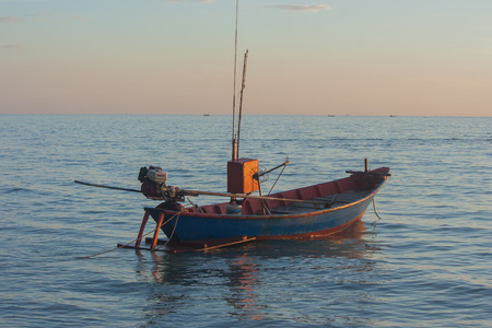 Tropical view of sea and fishing boats with sunset light at Chao Lao Beach, Chanthaburi Province, Thailand.の写真素材