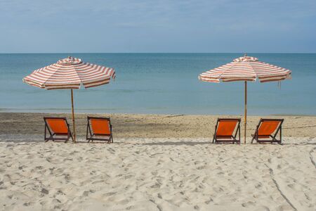 Chairs with umbrella on beach at Chao Lao Beach, Thailand.の写真素材