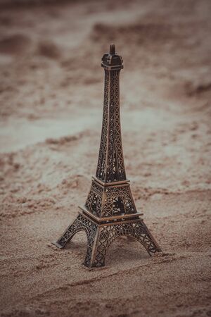 Little model of Eiffel tower on the beach with vintage effect.の写真素材