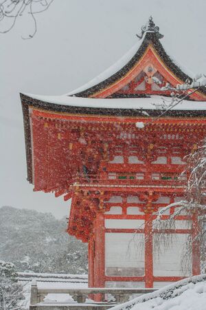 Red Pagoda at Kiyomizu-dera temple with tree covered white snow background at Kyoto, Japan.の写真素材
