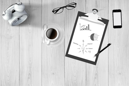 Business Creative and Innovation Concept : Coffee cup, glasses, smartphone, pen, notebook and alarm clock on desk.の写真素材