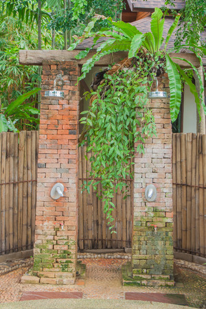 Shower head at outdoor around natural green tree.の写真素材