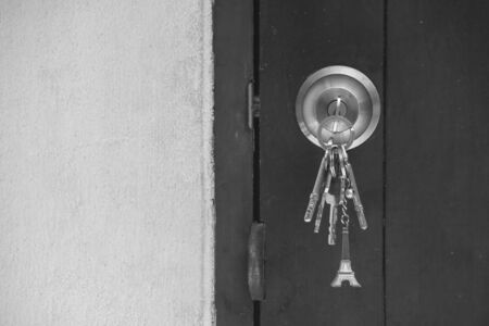 Old wooden door key knob with keys. (Black and White filter effect)の写真素材