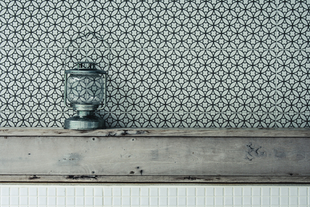 Vintage kerosene oil lantern lamp standing on wooden shelf with texture wall background. (Vintage filter effect)の写真素材