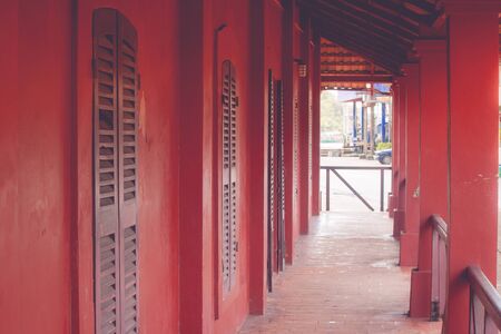 Tunnel walkway or footpath in old red buildings. (Vintage filter effect)の写真素材