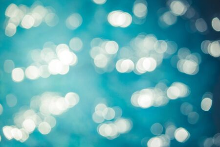 Abstract blurred image of sparkling blue water with bokeh background in swimming pool.の写真素材