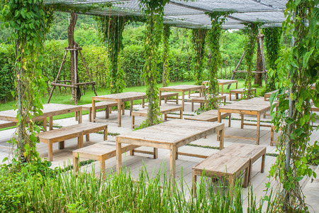 Wooden chair and table in beautiful garden at outdoor.の写真素材