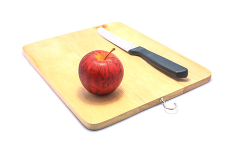 red apple on chopping board の写真素材
