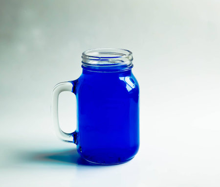 Blue water jug ââon a white backdrop.の写真素材