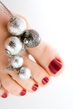 young female feet with pedicure isolated in white background