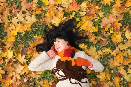 Young pretty woman in the autumn parkの写真素材