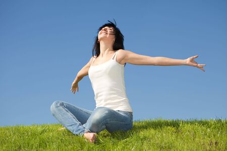 happy young woman dreams to fly on windsの写真素材