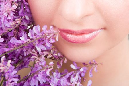 Smile of young woman with flowers の写真素材