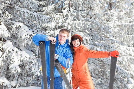 Happy couple with ski in the winter landscapeの写真素材