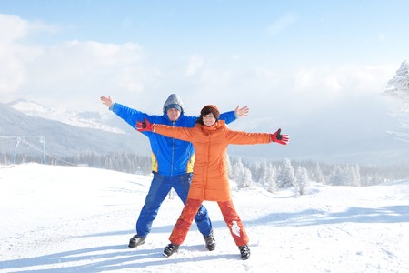 Happy couple with ski in the winter landscape 
の写真素材