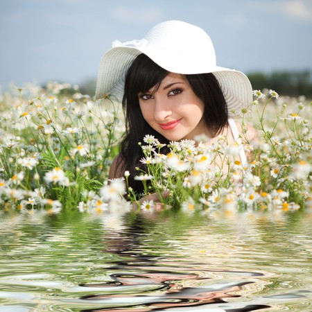 young happy girl in the camomile field の写真素材