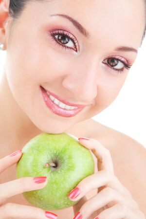 sweet girl eating green apple on white background の写真素材