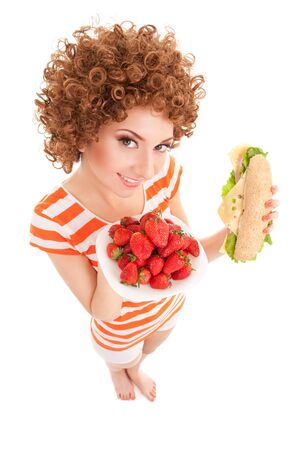 Fun woman with strawberry and sandwich on the white backgroundの写真素材