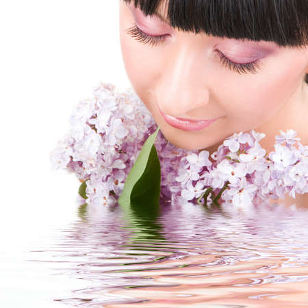 Young woman with lilac flowers の写真素材