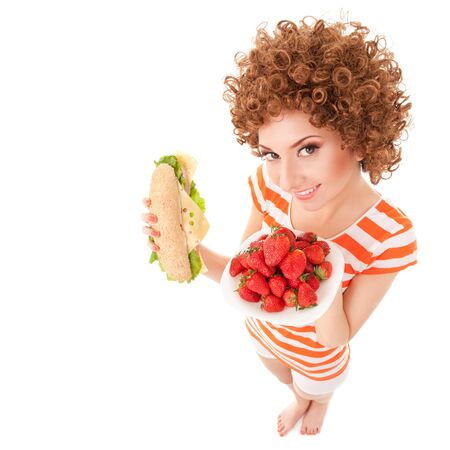 Fun woman with strawberry and sandwich on the white backgroundの写真素材