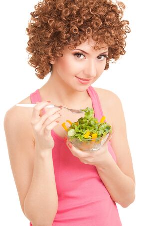 fun woman eating the salad on the white backgroundの写真素材