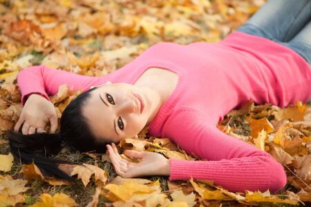 Young pretty woman rest in the autumn parkの写真素材