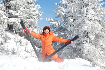 Happy girl with ski in the winter landscapeの写真素材
