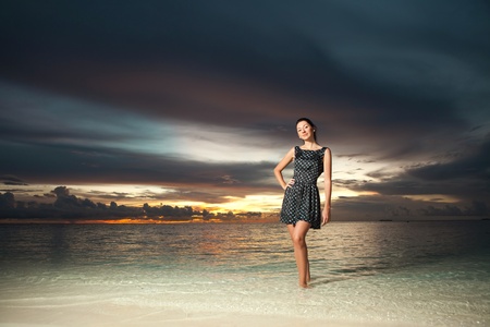 Fashion woman on the sea sunset backgroundの写真素材