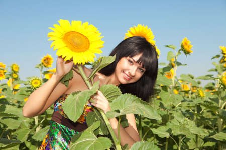 Young woman in the field of sunflowersの写真素材