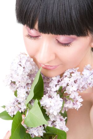 Young woman with lilac flowersの写真素材