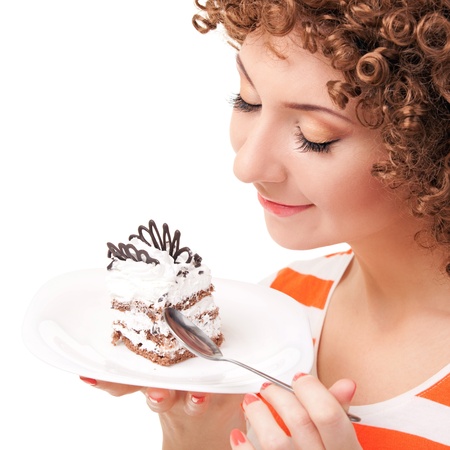 fun woman eating the cake on the white backgroundの写真素材