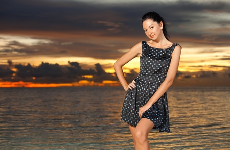Fashion woman on the sea sunset backgroundの写真素材