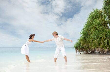 Young couple on the beach of seaの写真素材
