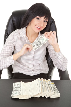 Elegant business woman with pile of moneyの写真素材